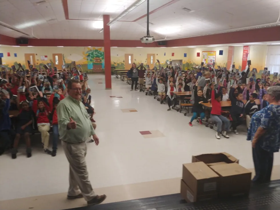 Rotarian handing a dictionary to a student